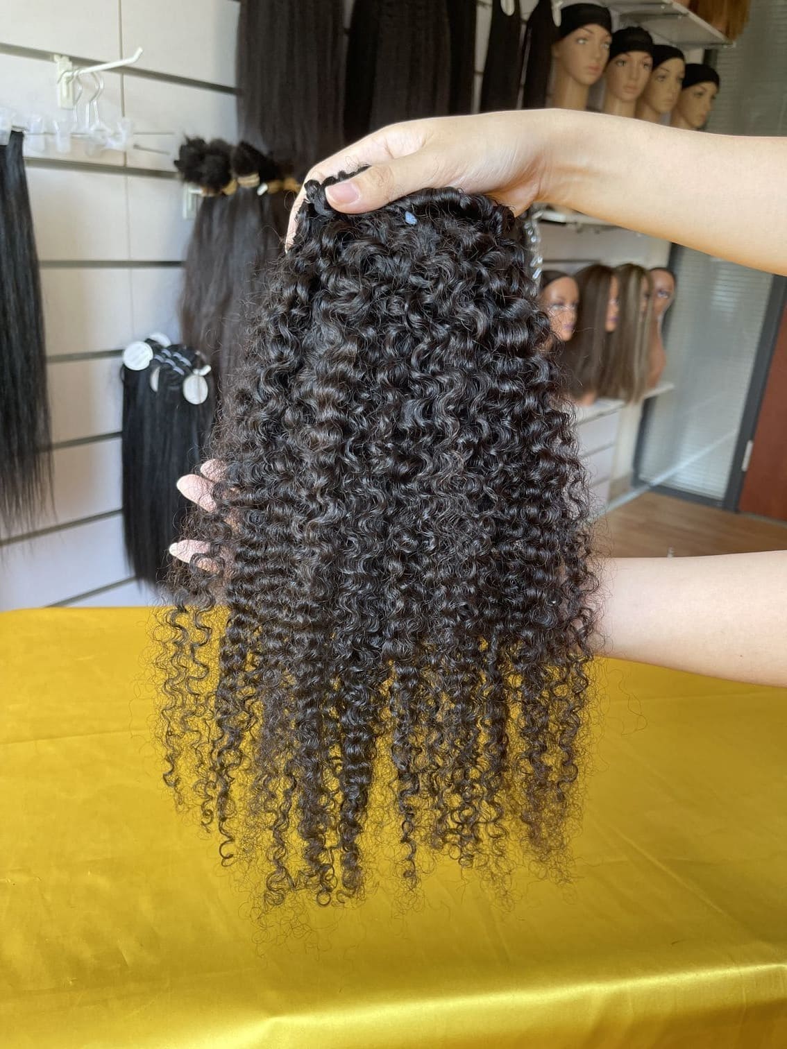 QWB Queen Weave Beauty - Product construction quality documentation showing reinforced weft attachment system. Machine double stitching anchors each hair strand to the base ensuring durability during extended wear periods. Close-up reveals minimal bulk at seam edges for comfortable lay-flat installa
