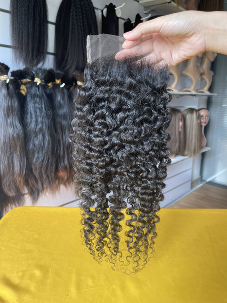 QWB Queen Weave Beauty - Product construction quality documentation showing reinforced weft attachment system. Machine double stitching anchors each hair strand to the base ensuring durability during extended wear periods. Close-up reveals minimal bulk at seam edges for comfortable lay-flat installa