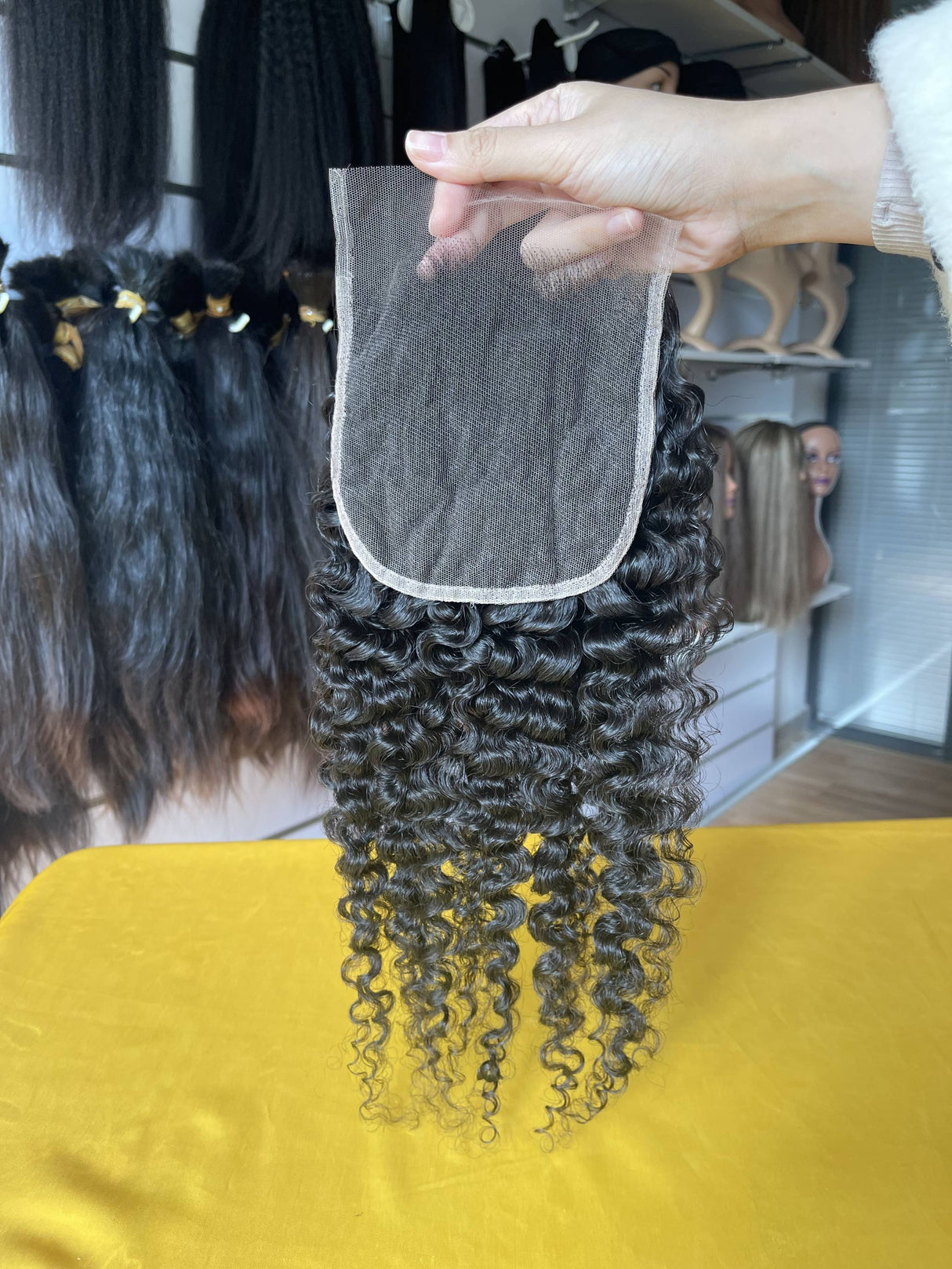 QWB Queen Weave Beauty - Detailed texture verification macro photography documenting distinctive S-pattern tight ringlets with high-volume bouncy texture. Close inspection reveals uniform curl formation throughout entire strand length from weft edge through tip ends, confirming consistent steam proc