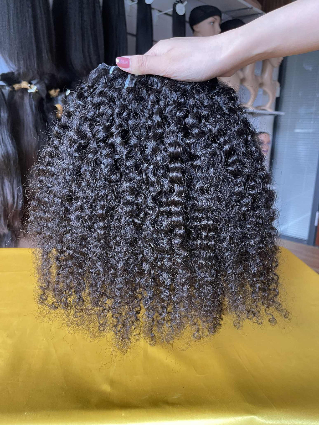 QWB Queen Weave Beauty - Detailed texture verification macro photography documenting distinctive S-pattern tight ringlets with high-volume bouncy texture. Close inspection reveals uniform curl formation throughout entire strand length from weft edge through tip ends, confirming consistent steam proc
