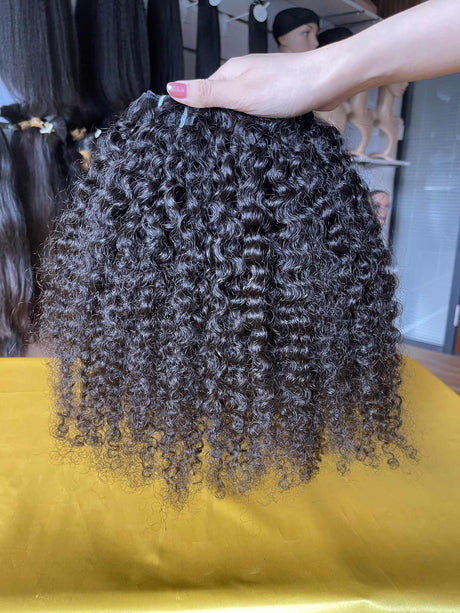 QWB Queen Weave Beauty - Detailed texture verification macro photography documenting distinctive S-pattern tight ringlets with high-volume bouncy texture. Close inspection reveals uniform curl formation throughout entire strand length from weft edge through tip ends, confirming consistent steam proc
