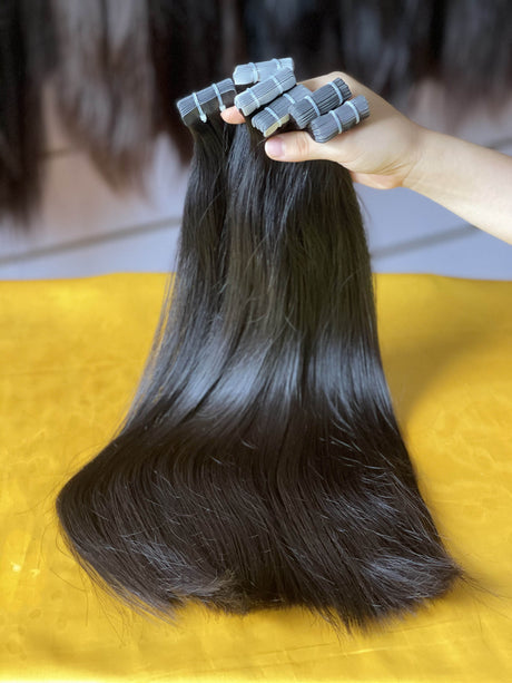 QWB Queen Weave Beauty - Product construction quality documentation showing reinforced weft attachment system. Machine double stitching anchors each hair strand to the base ensuring durability during extended wear periods. Close-up reveals minimal bulk at seam edges for comfortable lay-flat installa