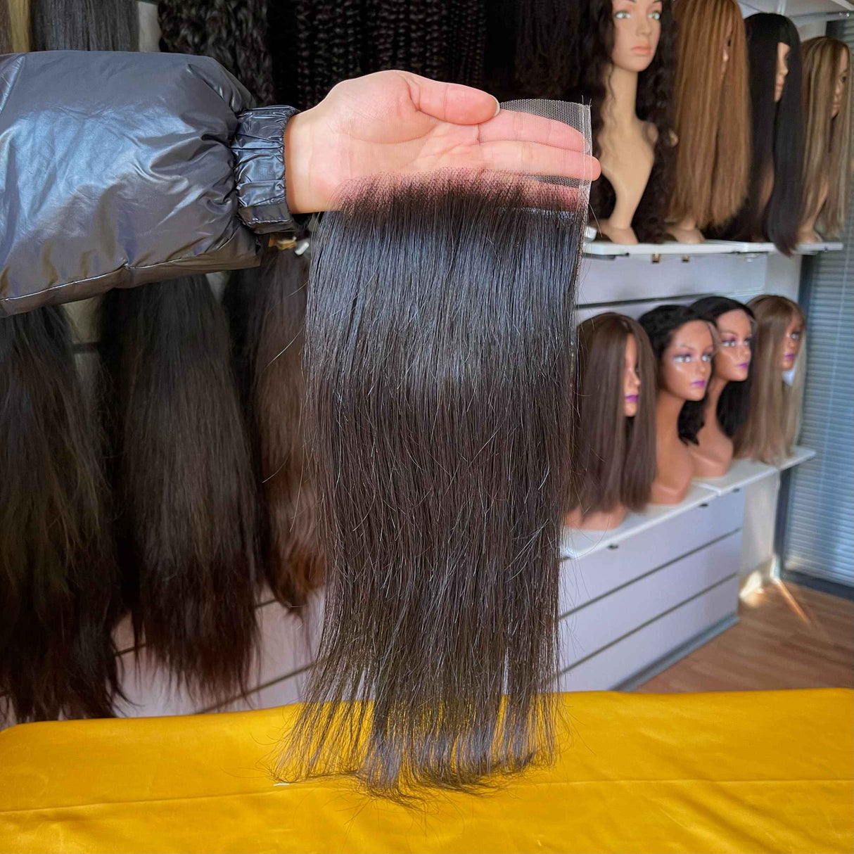 QWB Queen Weave Beauty - Detailed texture verification macro photography documenting premium virgin human hair. Close inspection reveals uniform curl formation throughout entire strand length from weft edge through tip ends, confirming consistent steam processing during manufacturing. Cuticle intact