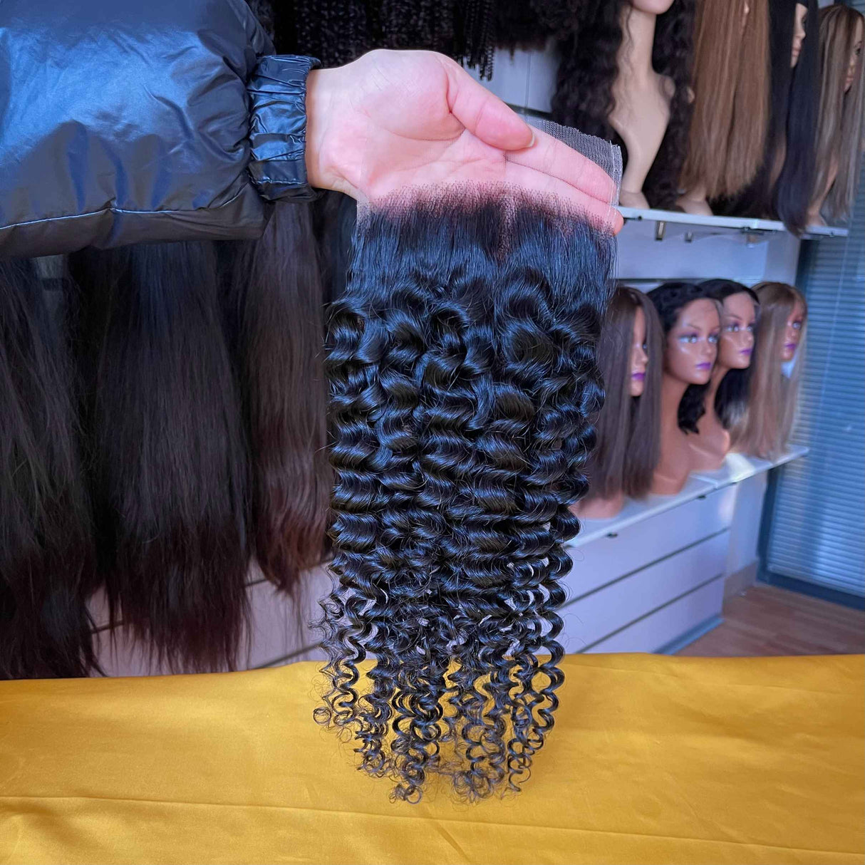 QWB Queen Weave Beauty - Detailed texture verification macro photography documenting compact tight curly ringlet formation with defined spiral coils. Close inspection reveals uniform curl formation throughout entire strand length from weft edge through tip ends, confirming consistent steam processin