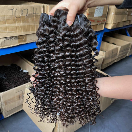 QWB Queen Weave Beauty - Detailed texture verification macro photography documenting compact tight curly ringlet formation with defined spiral coils. Close inspection reveals uniform curl formation throughout entire strand length from weft edge through tip ends, confirming consistent steam processin
