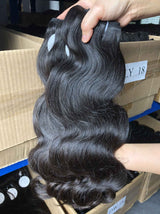 QWB Queen Weave Beauty - Detailed texture verification macro photography documenting premium virgin human hair. Close inspection reveals uniform curl formation throughout entire strand length from weft edge through tip ends, confirming consistent steam processing during manufacturing. Cuticle intact