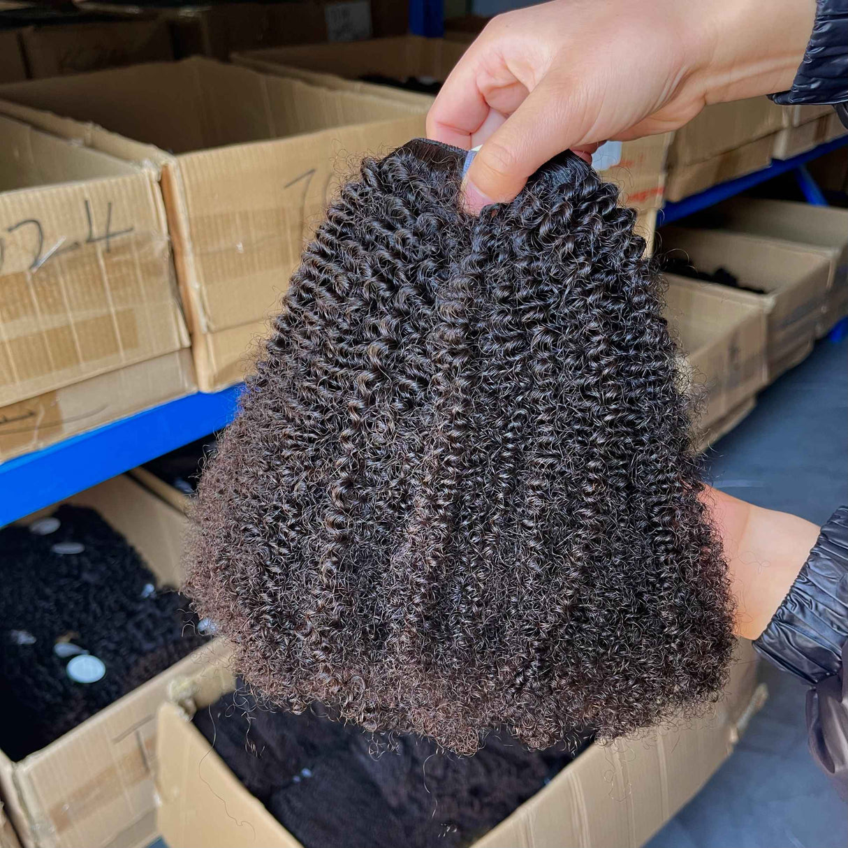 QWB Queen Weave Beauty - Detailed texture verification macro photography documenting tightly coiled curl pattern with dense springy texture. Close inspection reveals uniform curl formation throughout entire strand length from weft edge through tip ends, confirming consistent steam processing during 