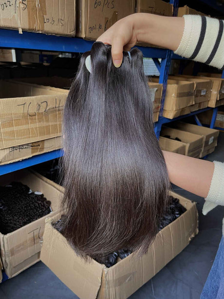 QWB Queen Weave Beauty - Product construction quality documentation showing reinforced weft attachment system. Machine double stitching anchors each hair strand to the base ensuring durability during extended wear periods. Close-up reveals minimal bulk at seam edges for comfortable lay-flat installa